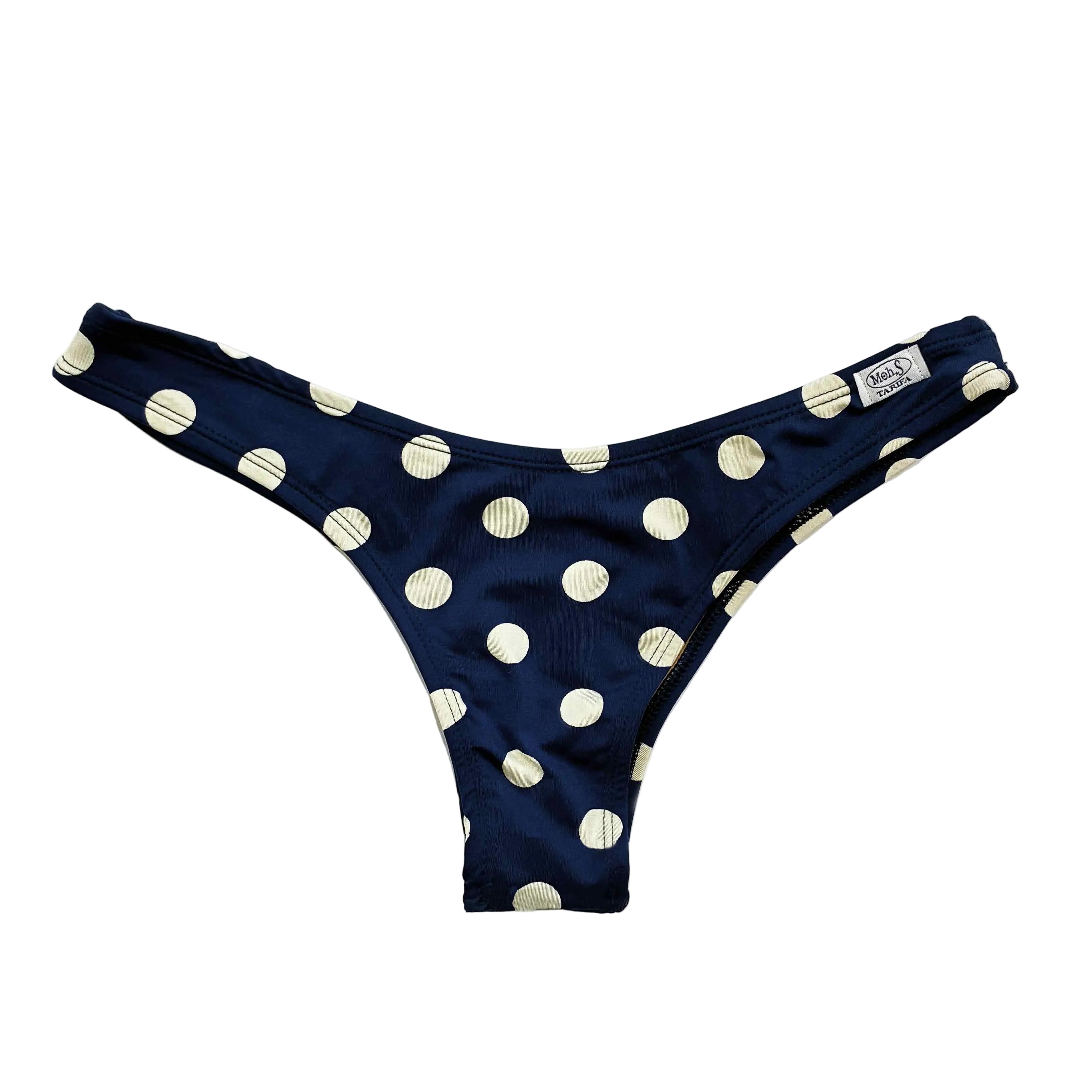 Braga de bikini artesanal tipo mini brasileña con corte en V en color azul marino y estampado de lunares blancos.