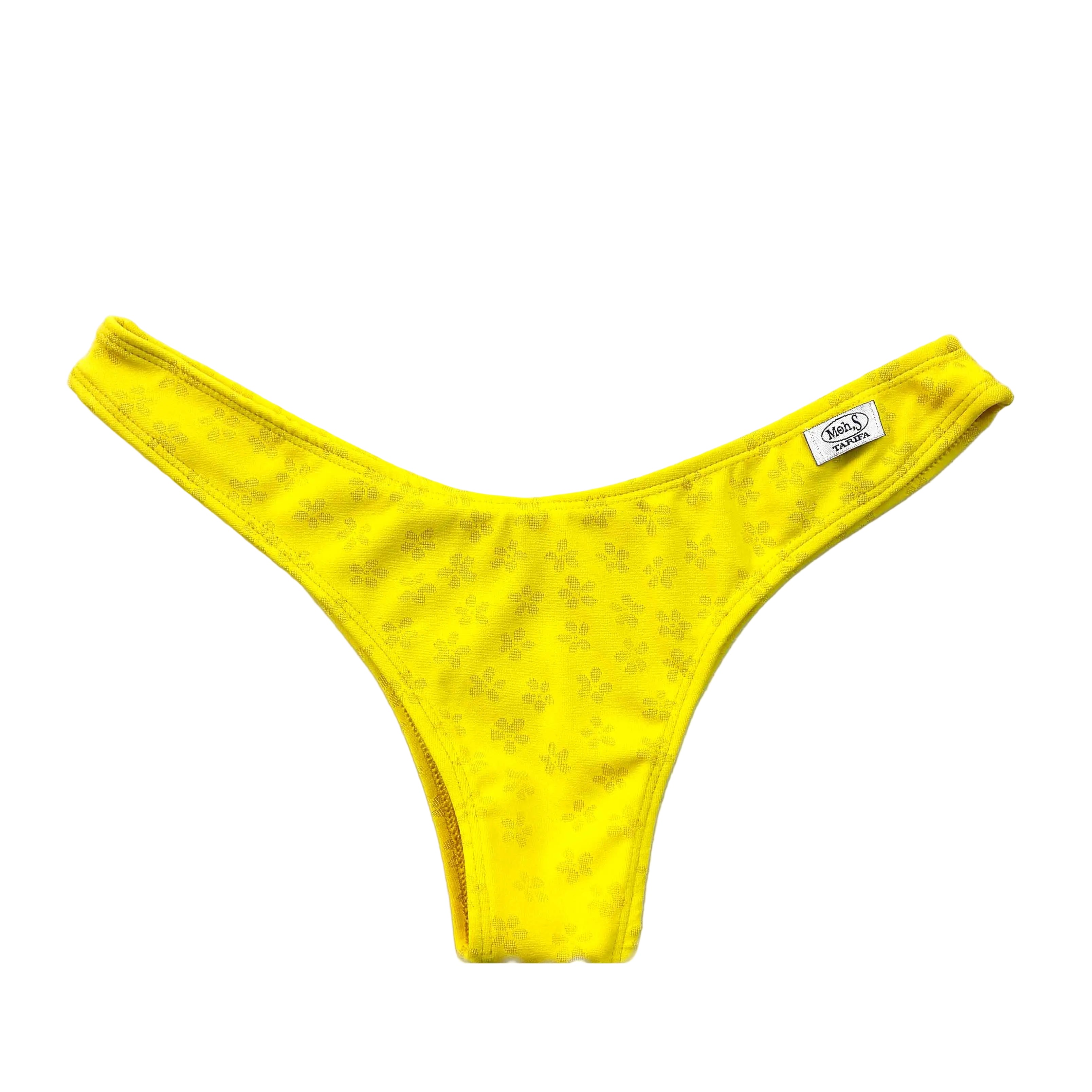 Braga de bikini brasileña de talle alto y corte en V, en color amarillo vibrante con un delicado patrón jacquard de flores tonales. Incluye etiqueta Moh,S en el lateral.