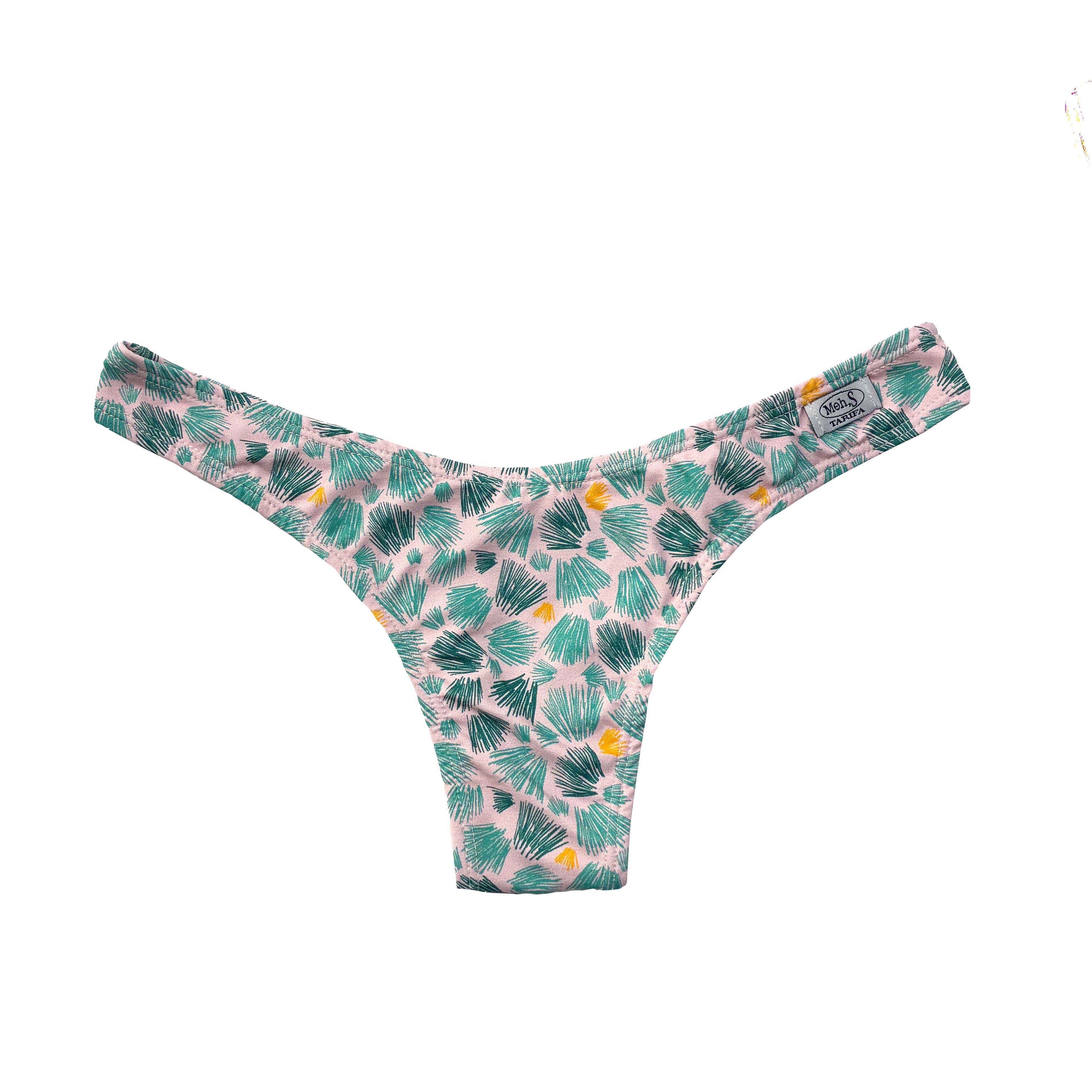 Braguita de bikini con corte en V y estampado de palmeras en tonos verdes y amarillos sobre fondo rosa palo.